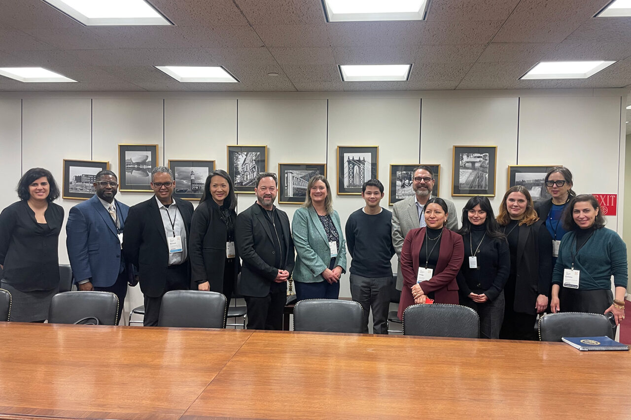 Group of people standing posing in a conference room