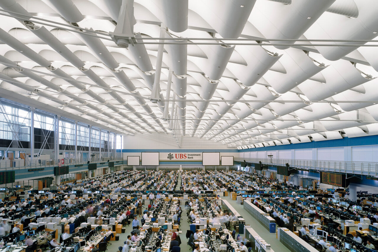 Interior UBS trading crowded room.