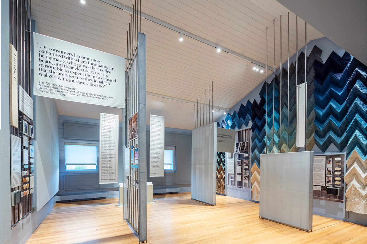 Interior of exhibition space featuring fibers and fabrics.