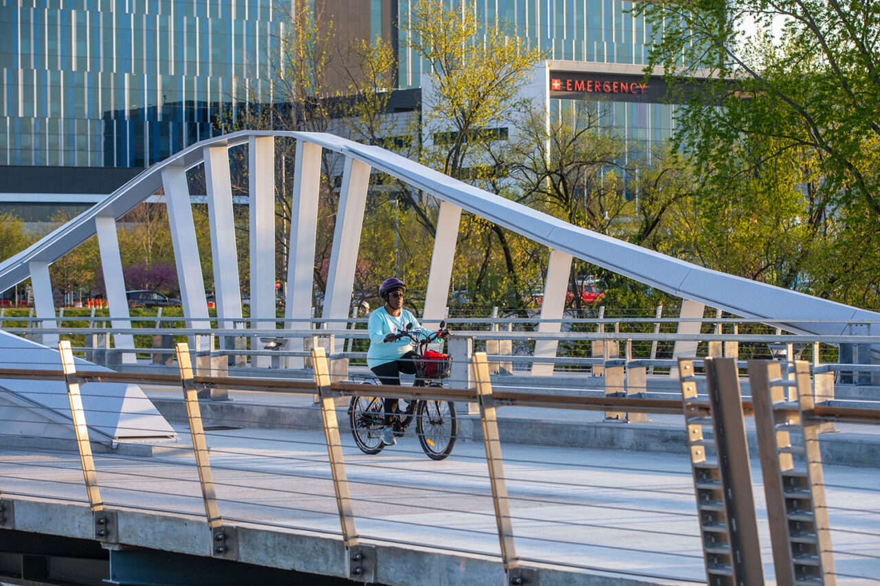 A person on a bike along the 16 Tech Wave Bridge.