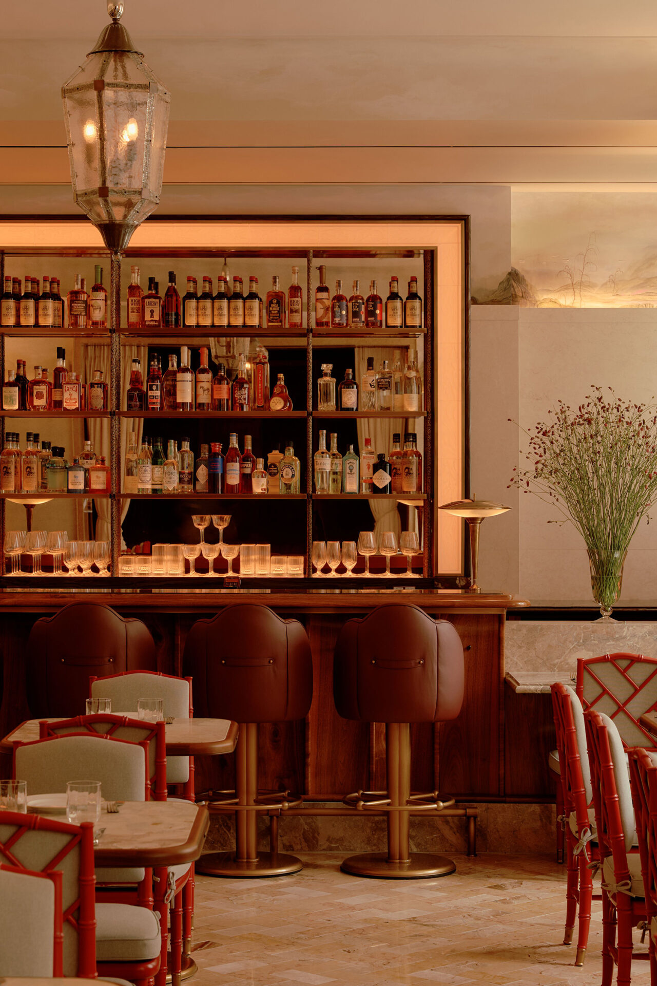 Vertical interior of warmly lit bar scene.