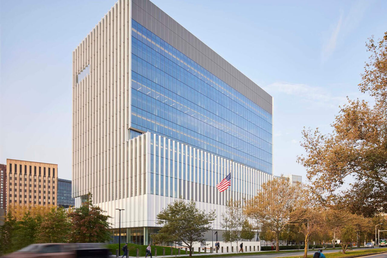 Exterior of US DOT building with white paneled façades in Cambridge, MA.