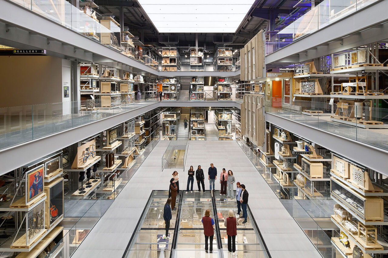 Interior of V&A East Storehouse from a top view, showing people walking along the glass floor below.