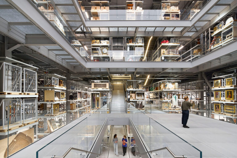 Interior of V&A East Storehouse, from a lower level showing the floors above and people scattered throughout.