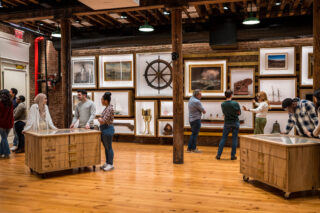 Several exhibition vitrines sit on the ﬂoor atop casters