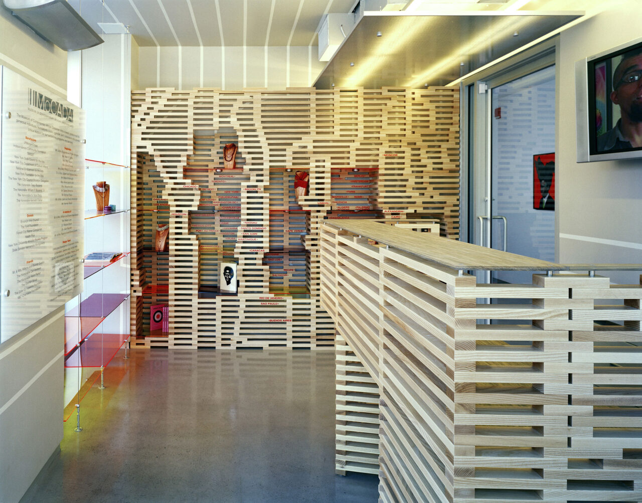 J. Yolande Daniels of studioSUMO designed the original concept for oCADA/The Museum of Contemporary AfricanDiasporan Arts, which was built in 2007 and located in the BAM cultural district in Fort Greene, Brooklyn. Visitors entering fromthe street encountered a map of the African diaspora that was spatialized in both two and three dimensions. Constructed from more than 2,500 pieces of stacked ash, the reception furnishings were at once display wall, reception desk, and office screen. Photo: © Frank Oudeman.