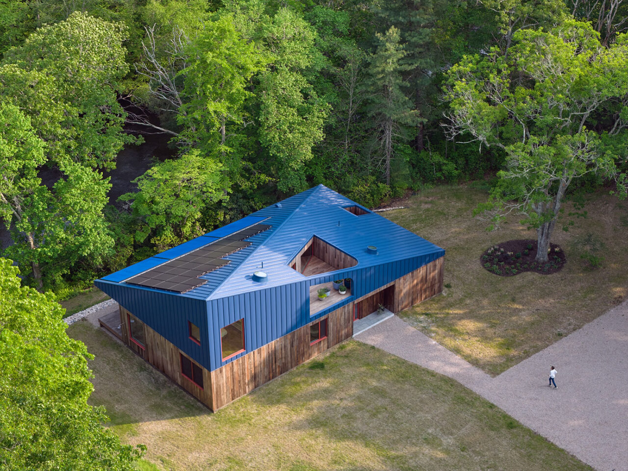 Aerial view of a modern cabin in the woods