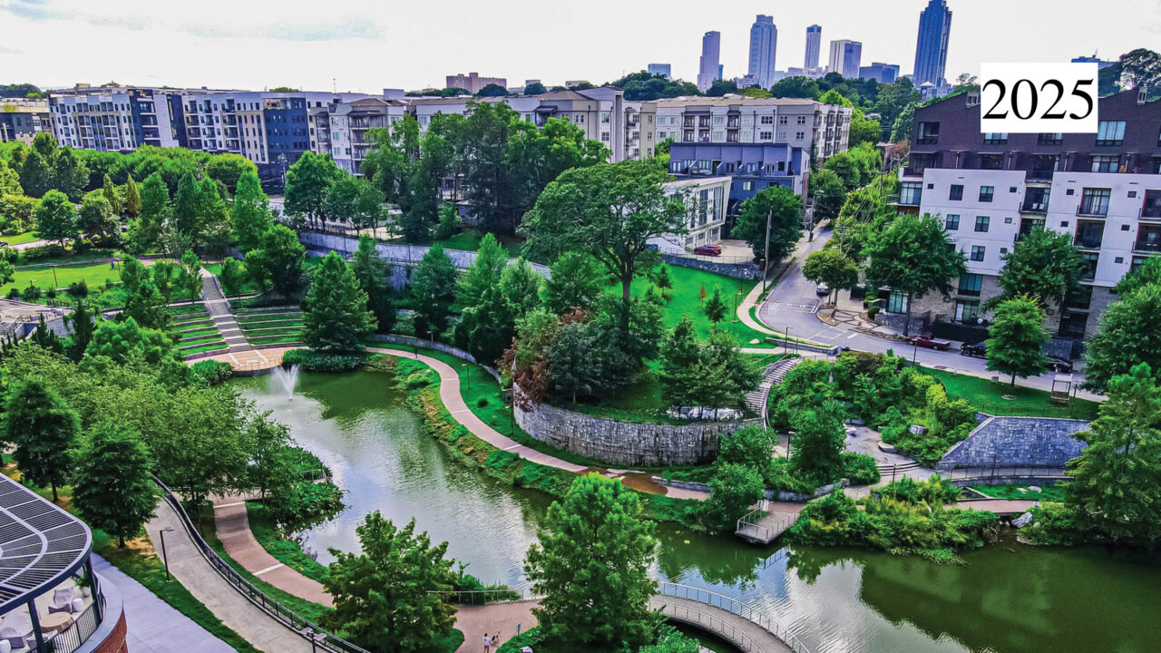 A birds-eye view of a lush green riverside park