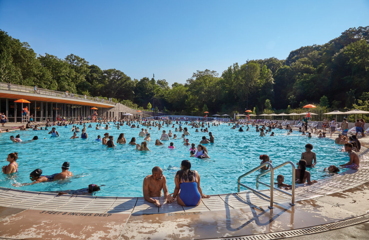 A ground level view of the new pool with people swimming in it
