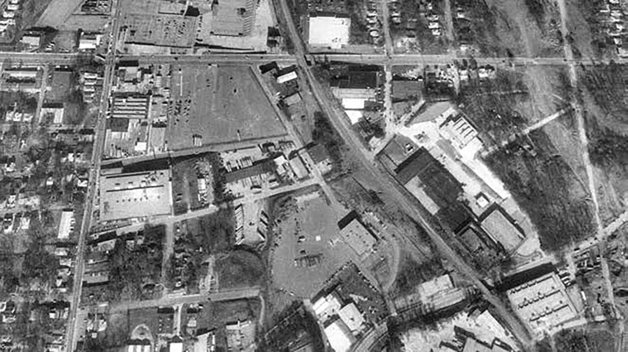 A black and white aerial photograph of aneighborhood