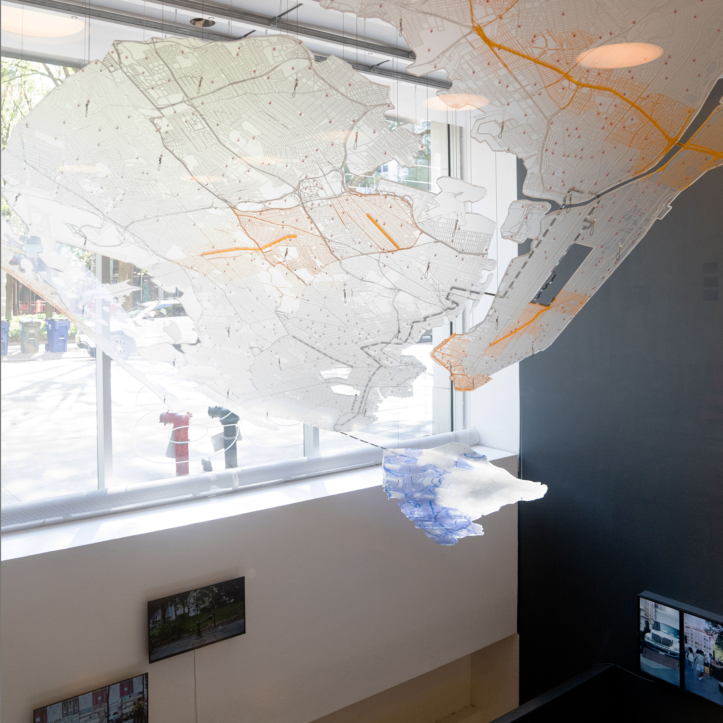 Searching for Superpublics installation view of a map suspended from the ceiling