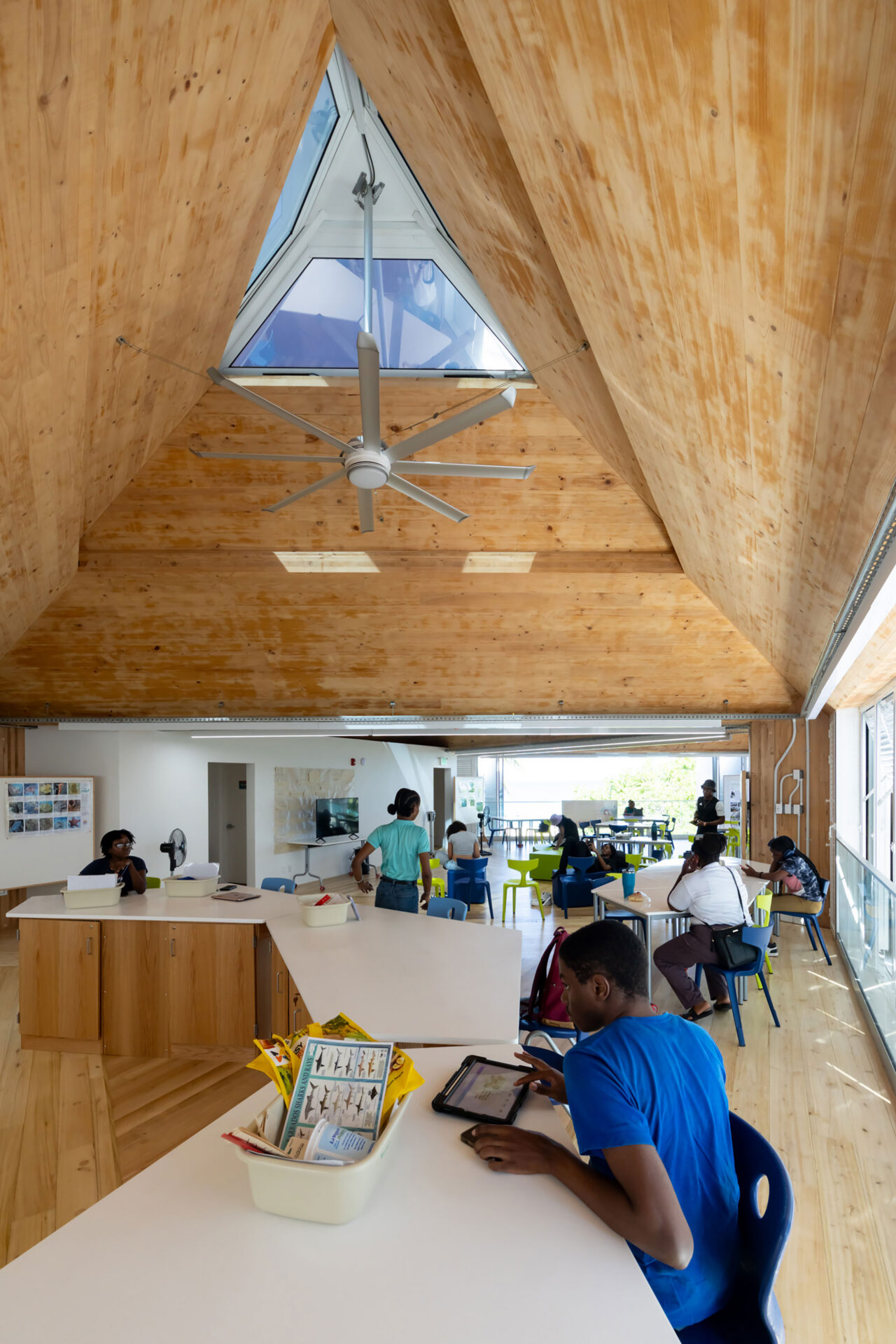 The mass timber modules of the Oceana Innovation Hub are clad in louvered accordion shutters and topped with operable skylights that harness prevailing ocean breezes, vent hot air, and modulate the near-constant Caribbean sun, creating shaded, comfortable interiors while significantly reducing energy loads.