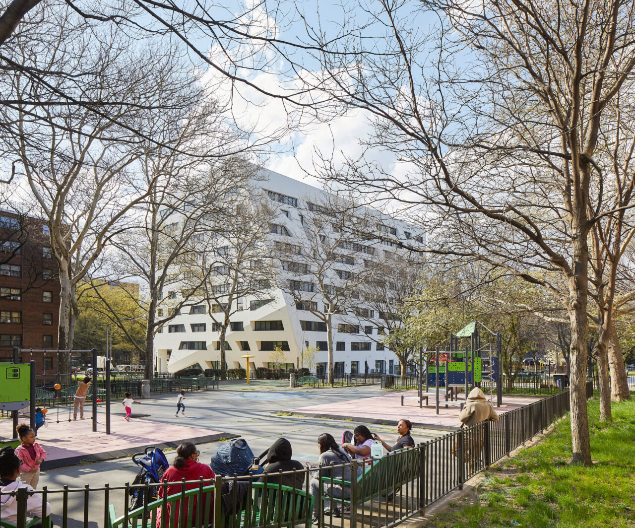Studio Libeskind’s The Atrium at Sumner is located in the parklike setting of the existing Sumner Houses campus along Marcus Garvey Boulevard in Brooklyn. It features affordable housing along with a ground-level community facility.