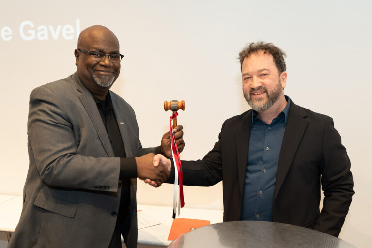 The passing of the gavel from 2025 AIANY President Benjamin Gilmartin, AIA, to 2026 AIANY President Mark Gardner, AIA, NOMA. Photo: Samuel Lahoz.