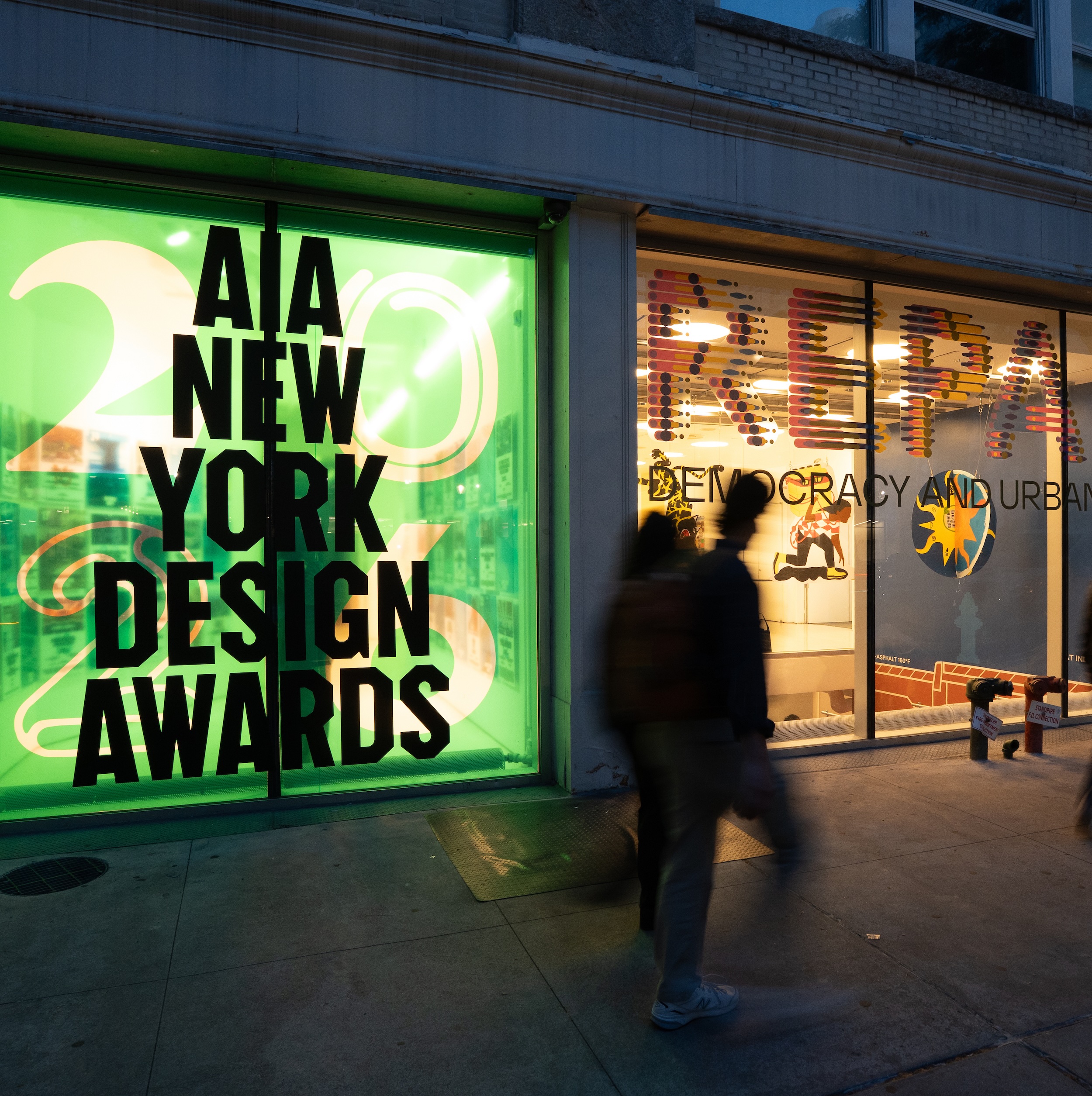The Center for Architecture exterior at night with glass storefront illuminated from inside