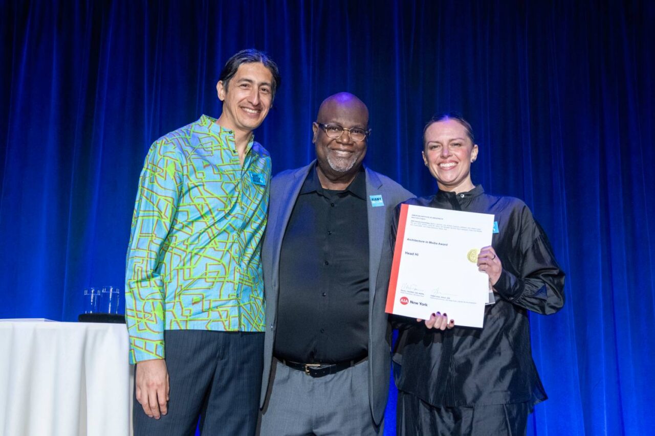 Head Hi co-founders Alvaro Alcocer and Alexandra Hodkowski receive the Architecture in Media Award, pictured with 2026 AIANY President Mark Gardner, AIA, NOMA. Photo: Matthew Carasella.
