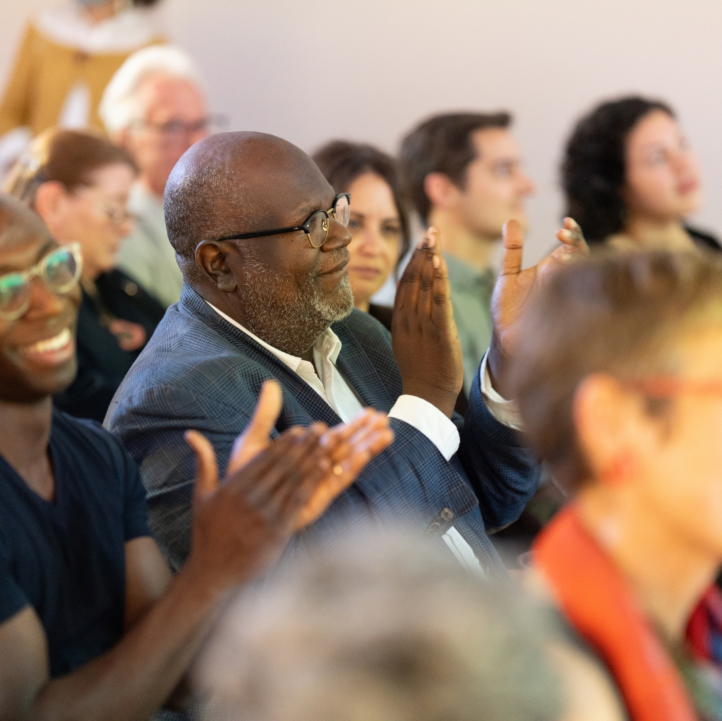 Annual Meeting photo of people clapping in the audience