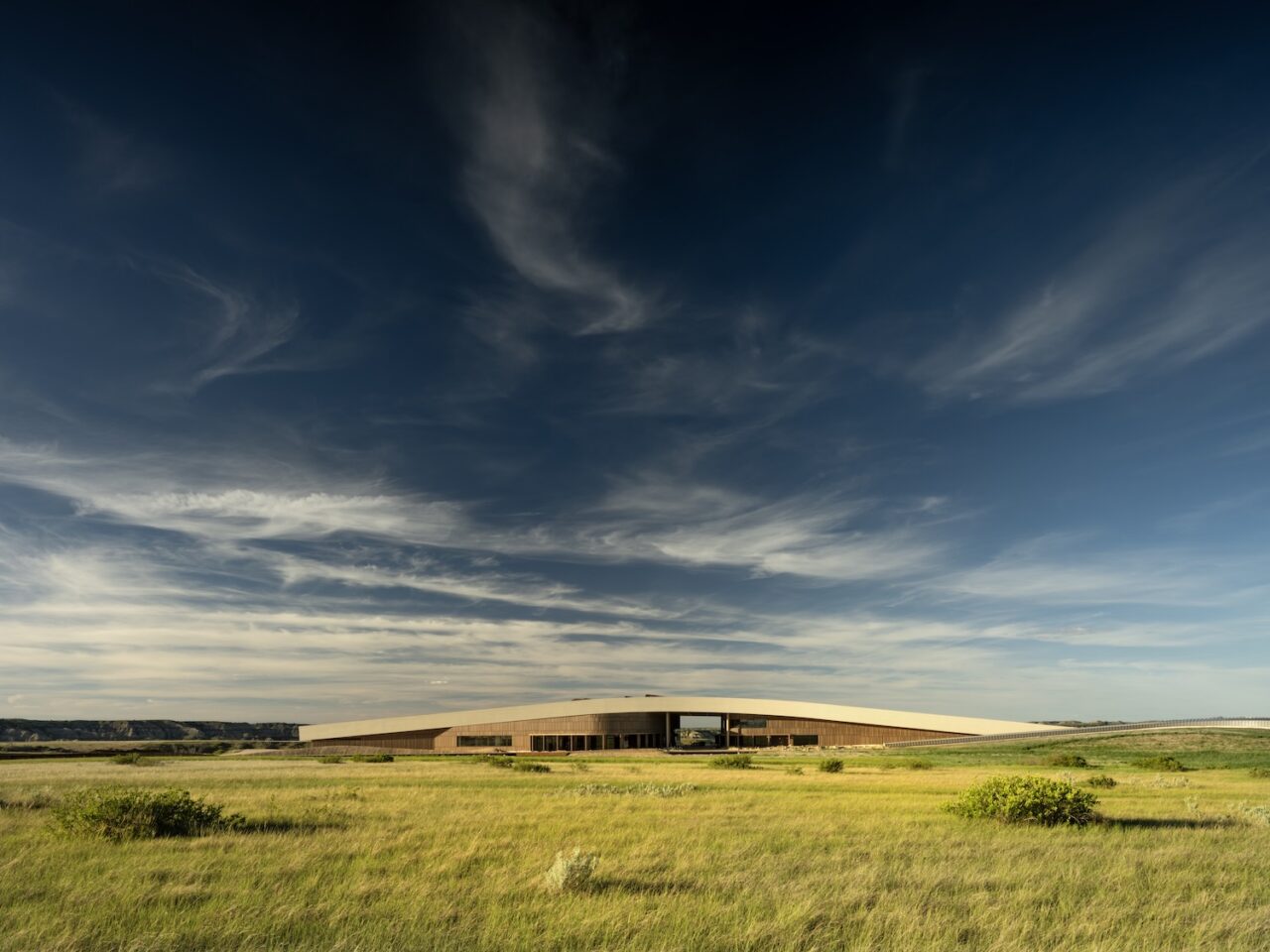 Exterior of the Theodore Roosevelt Presidential Library in North Dakota set amongst the prairie.