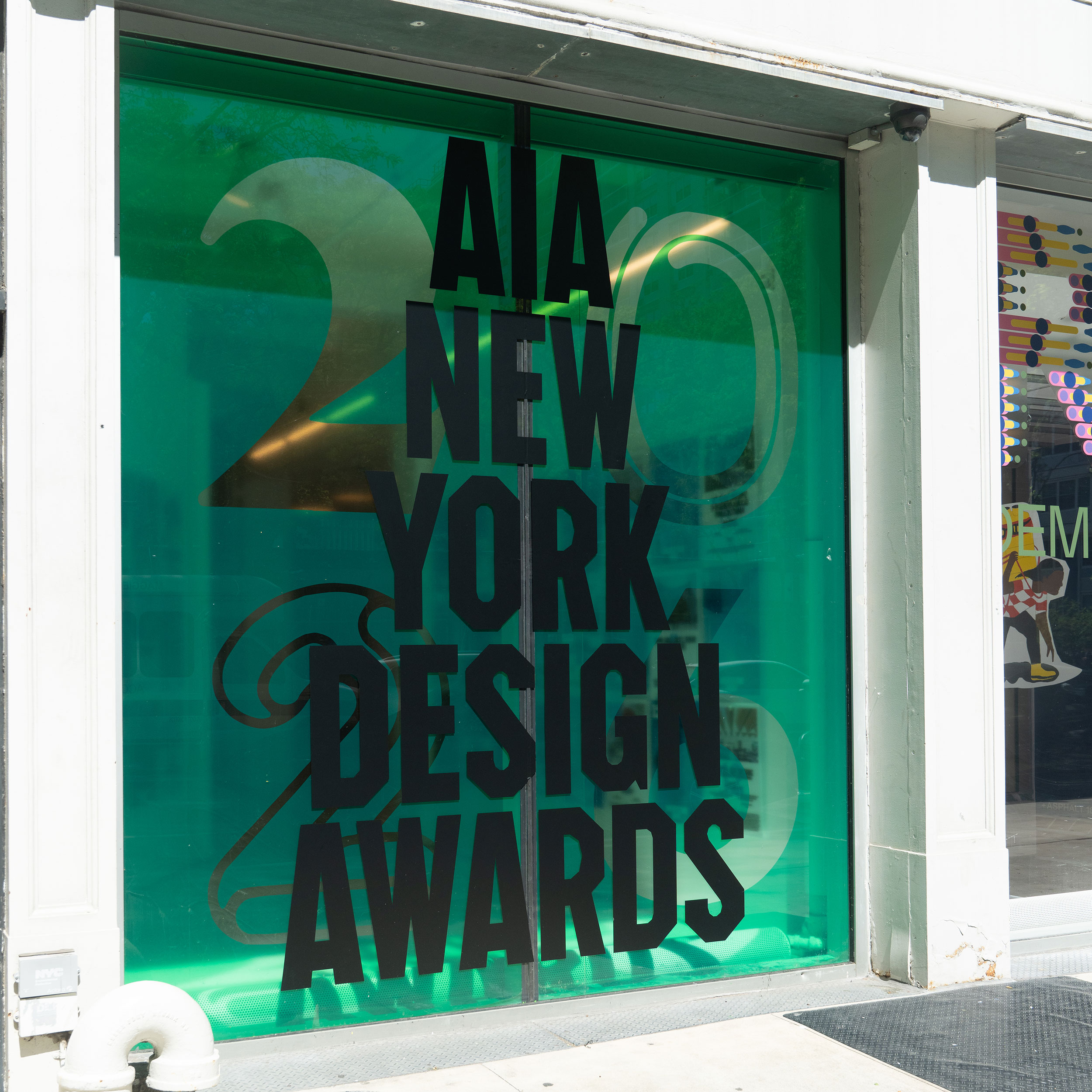 AIANY Design Awards graphic installed on the Center for Architecture glass storefront