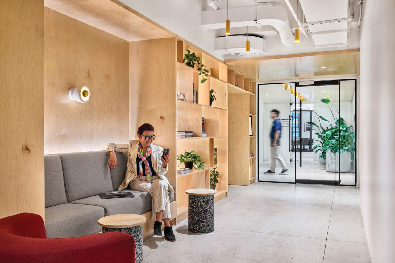 Interior office space with a seating alcove and shelving in a hallway