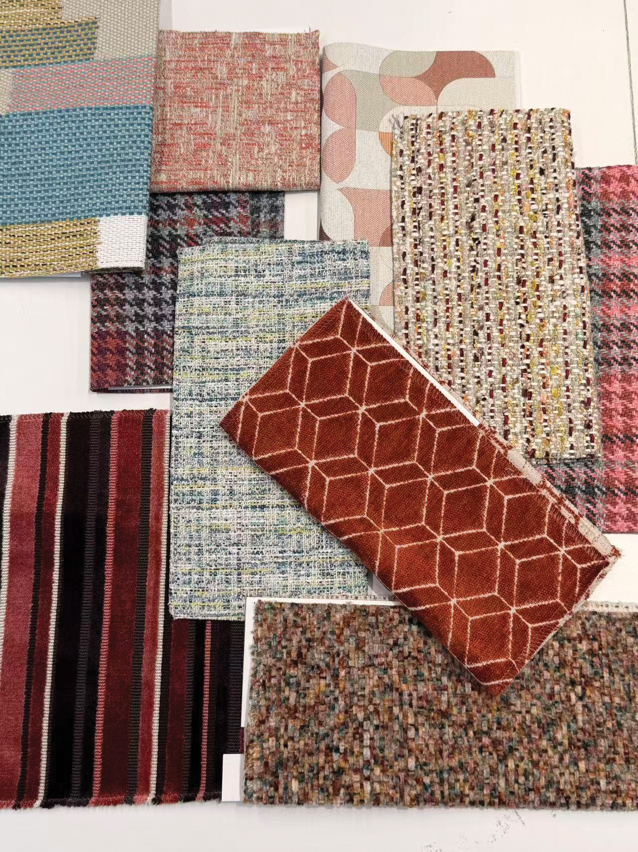 Closeup of fabric or upholstery samples arranged on a white background