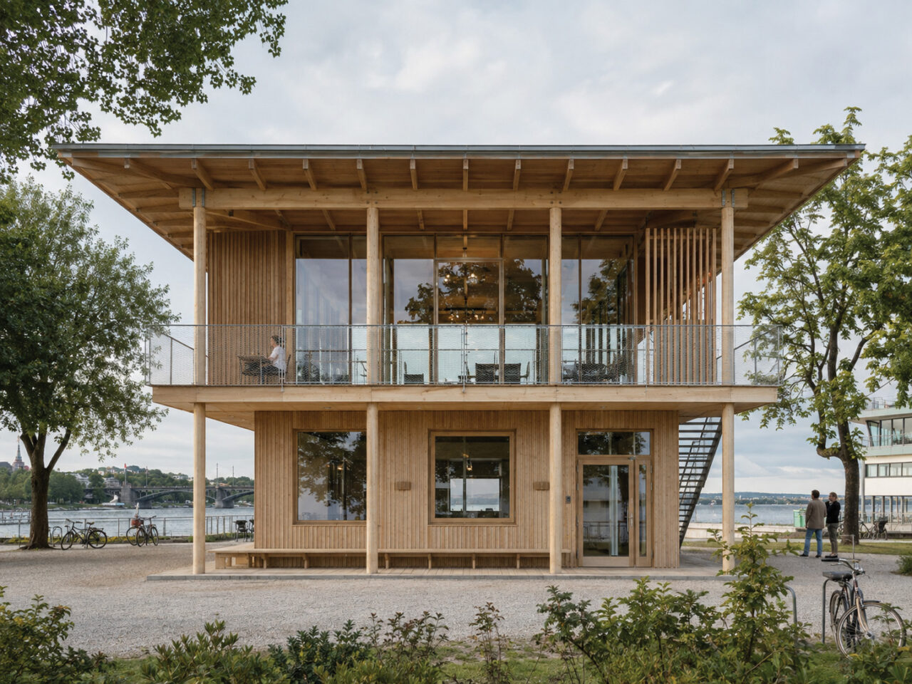 An AI-generated timber pavilion study exploring a lightweight structural frame, deep overhangs, and a highly open relationship between interior and landscape.