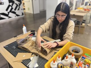 High School student working on a small model structure